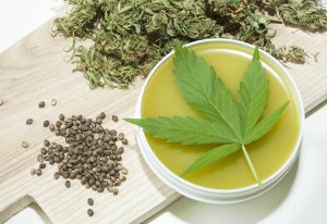 Cannabis healing ointment and marijuana leaf and seeds