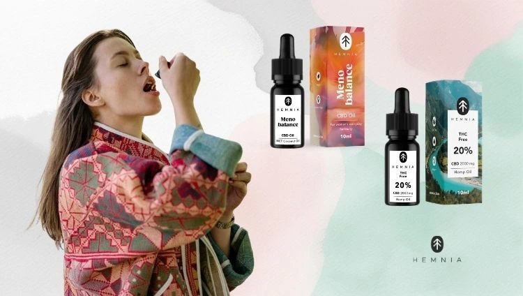 A woman using CBD oil, with Hemnia CBD oils next to her; the Hemnia logo is at the bottom right