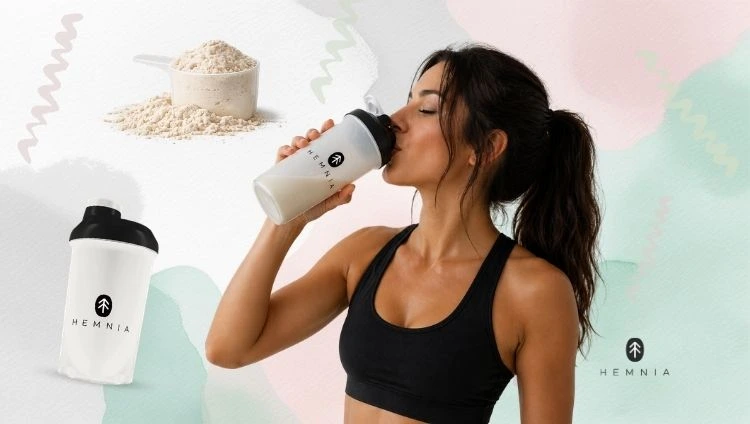 When to drink protein while losing weight: A woman drinking protein from a Hemnia shaker, next to a Hemnia shaker and protein powder in a measuring scoop