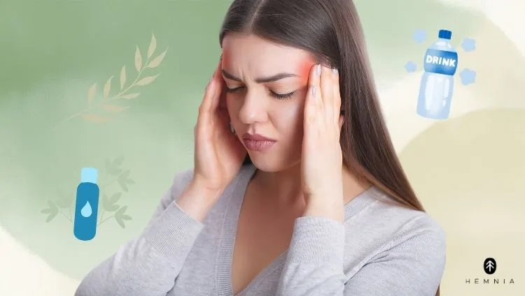 Symptoms of dehydration – a woman with a headache, which may be one of the signs of fluid deficiency